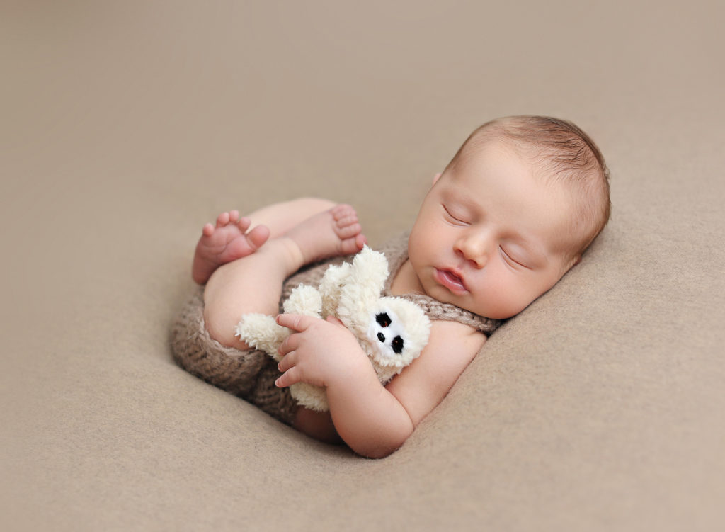 adorable newborn portrait, showcasing one of the poses and setups offered by San Diego's premier newborn photographer.