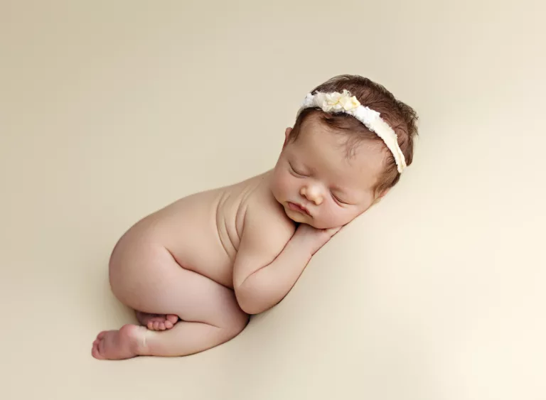 San Diego newborn photography in La Jolla. Baby posed in a side laying position during a studio newborn session in La Jolla