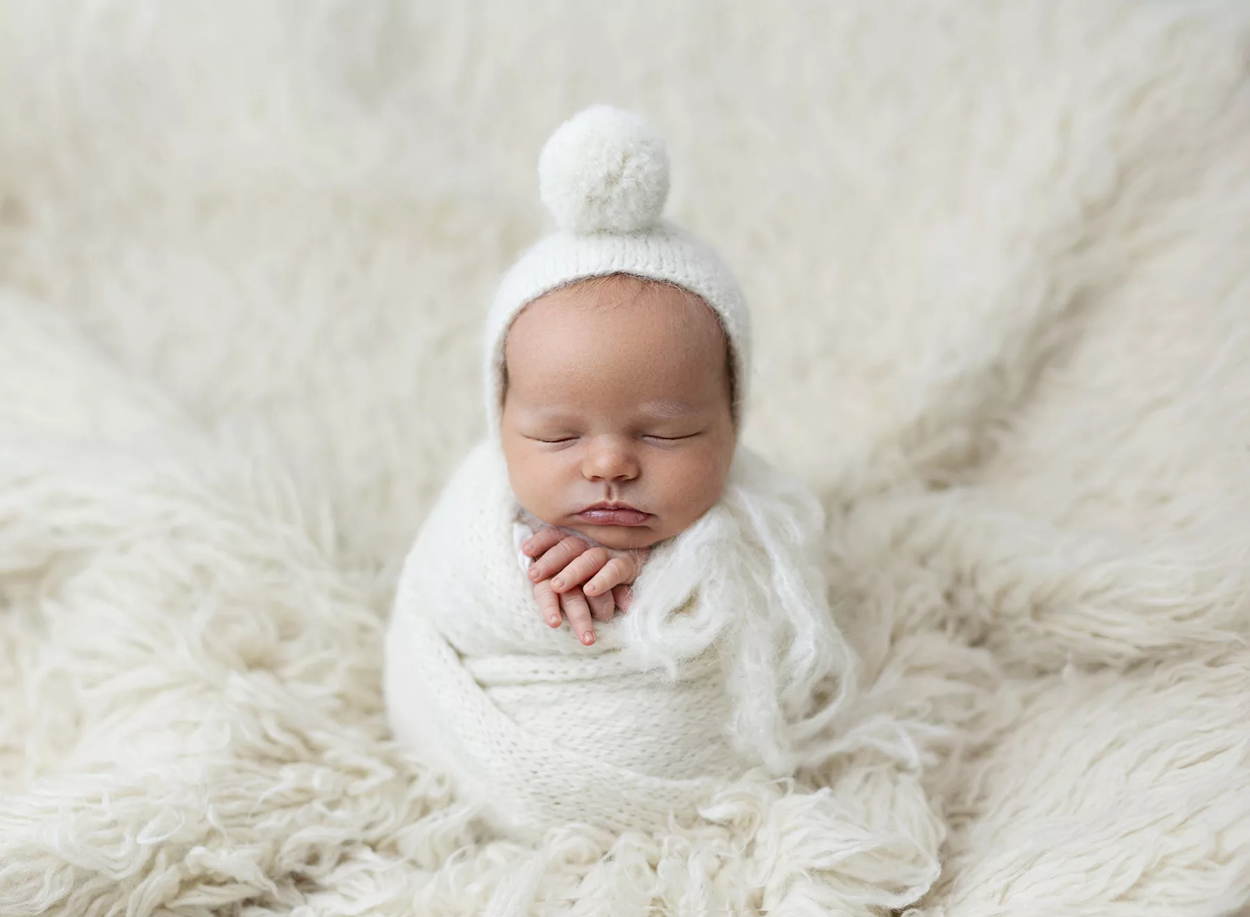 Newbon Photography San Diego CA Baby posing in neutral blanket